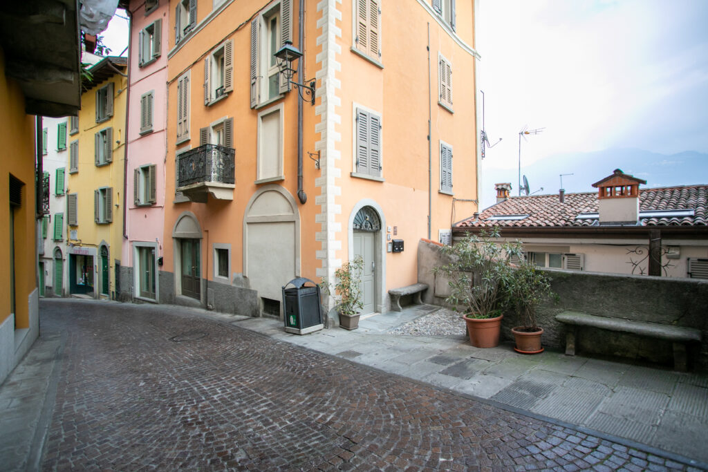 Colorful Italian street in Lovere with charming urban architecture and cobblestone path