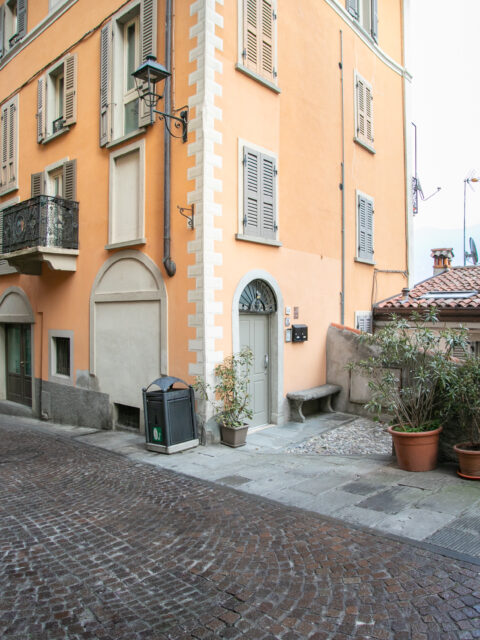 Colorful Italian street in Lovere with charming urban architecture and cobblestone path