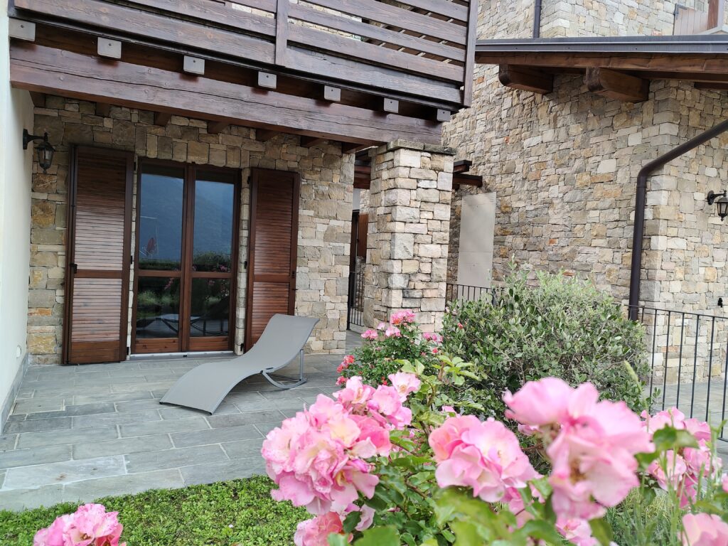 Casa Cuneo's charming entrance flanked by vibrant flowers, presented by Fabula Home Rental