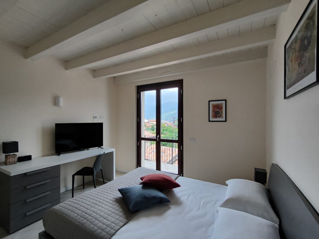 A chic bedroom suite with a stunning lake view balcony in Casa Cuneo at Fabula Home Rental