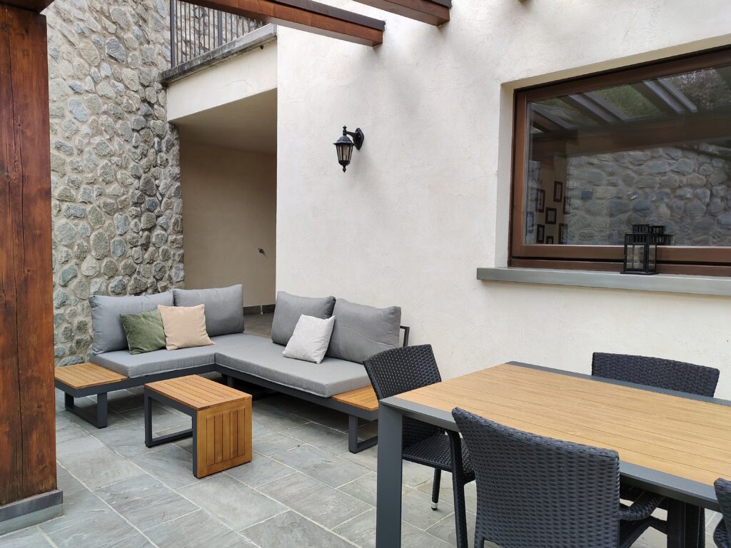 A serene outdoor living space with stylish seating at Casa Cuneo by Fabula Home Rental