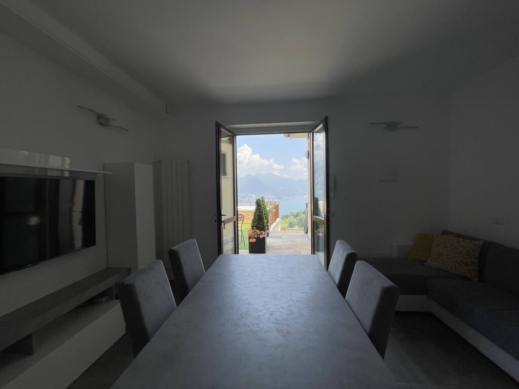 Open dining area leading to a balcony with a view at Casa il Nido, curated by Fabula Home Rental