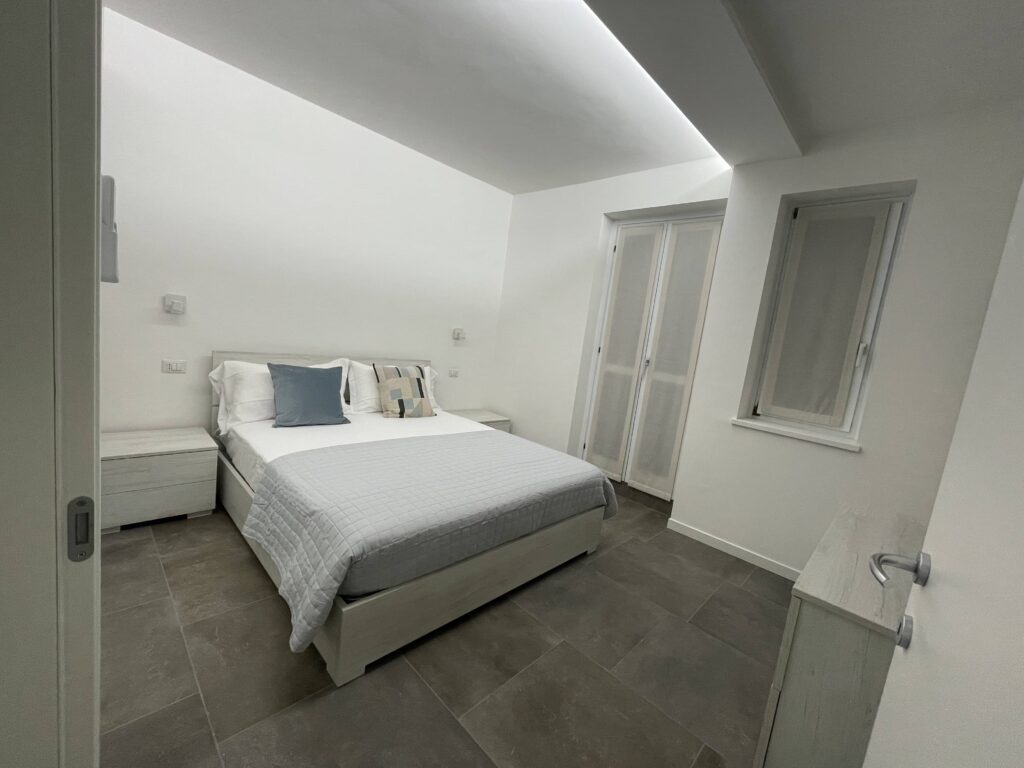 Modern bedroom with sleek design at Casa il Nido, offered by Fabula Home Rental