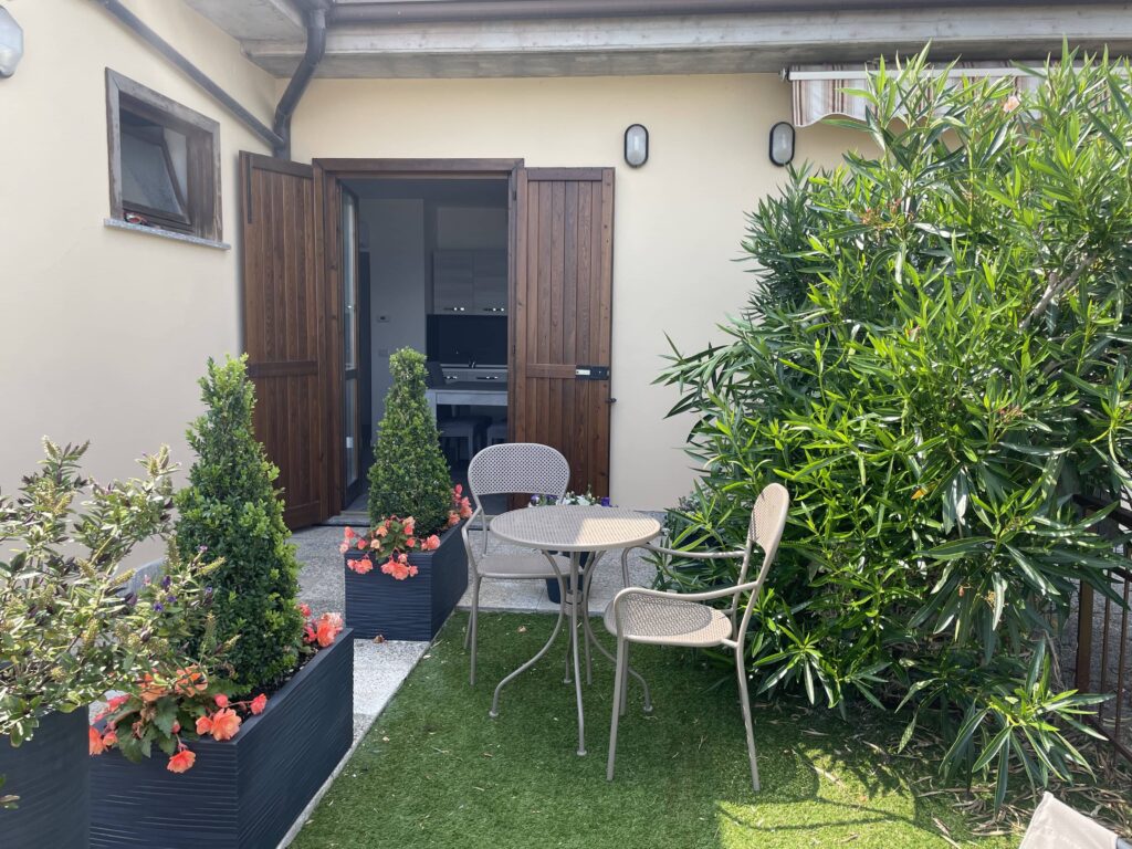 The welcoming patio entrance at Casa il Nido, adorned with lush plants, a feature of Fabula Home Rental properties