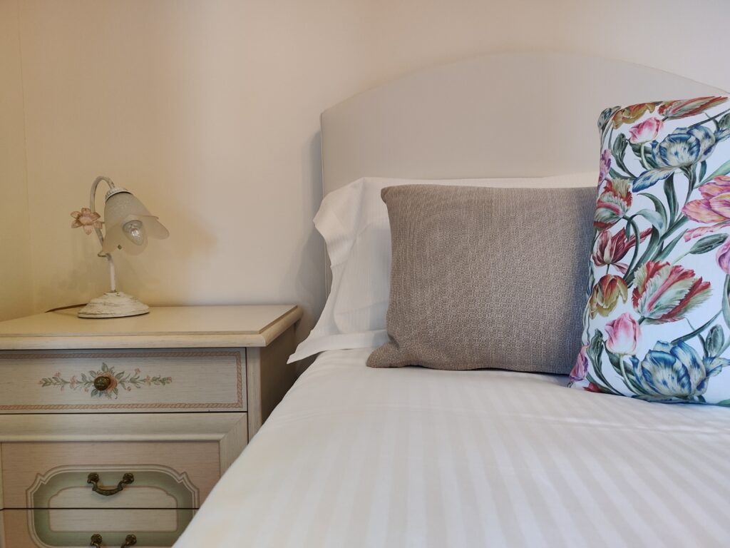 Serene bedroom with a charming nightstand and floral accents in GiannaRosa Apartment, Lovere