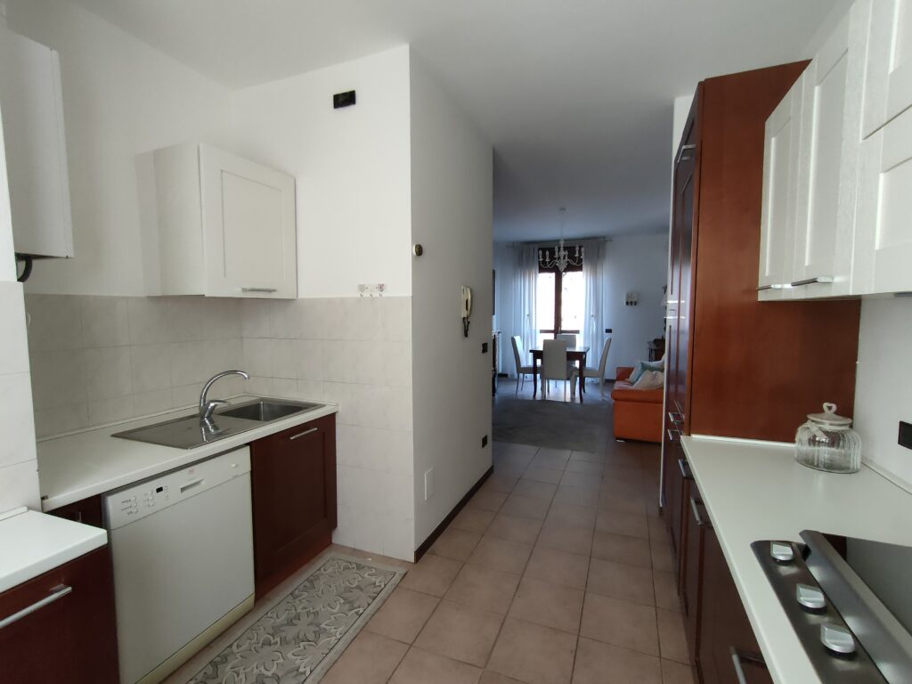 Modern and fully-equipped kitchen leading to a stylish living area in GiannaRosa Apartment, Lovere