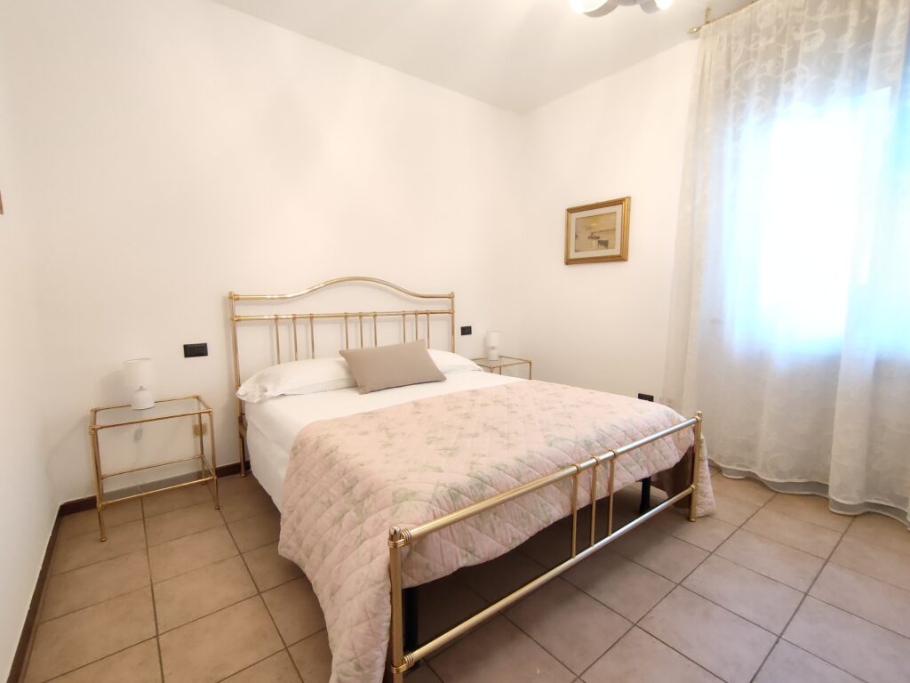 Luxurious master bedroom with golden bed frame and elegant decor in GiannaRosa Apartment, Lovere