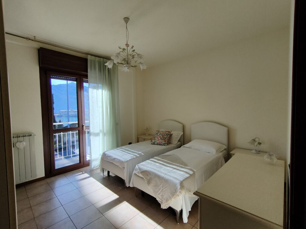 Comfortable twin bedroom with balcony access offering scenic views at GiannaRosa Apartment, Lovere