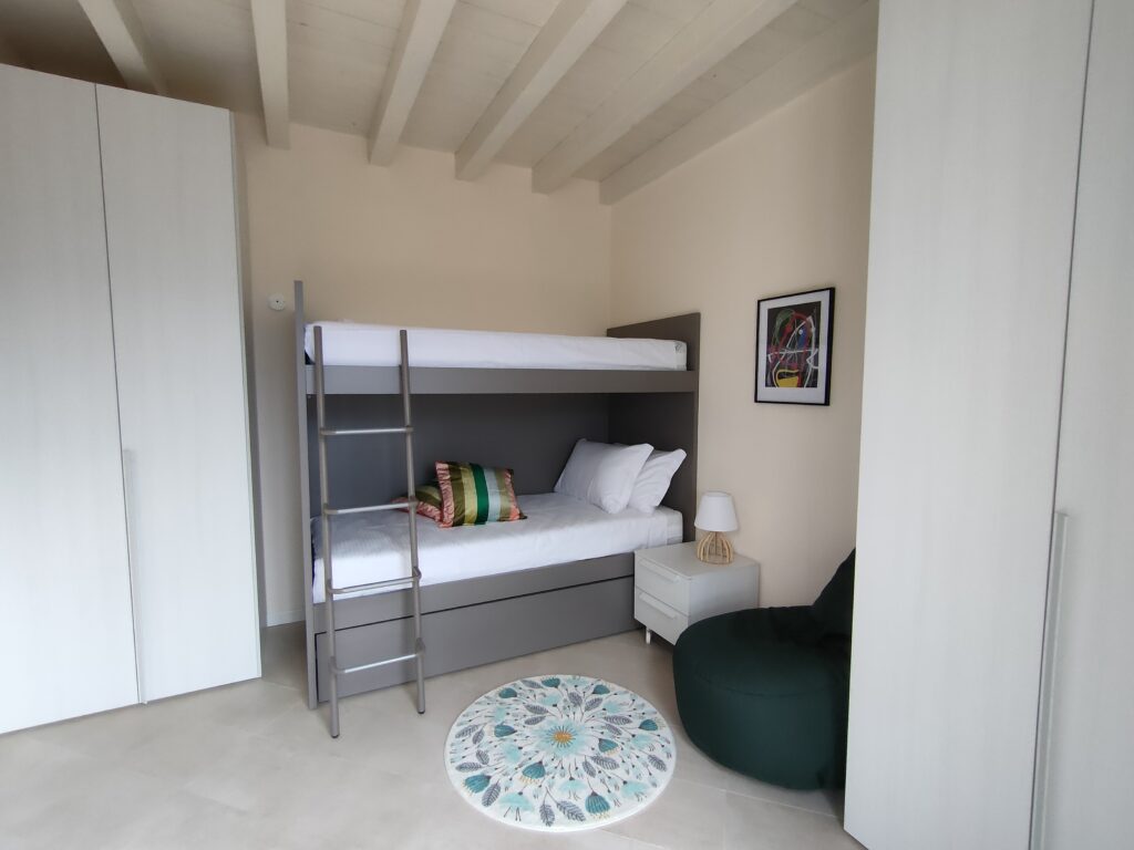 Artistic bunk bedroom with modern amenities at Fabula Home Rental, Lake Iseo