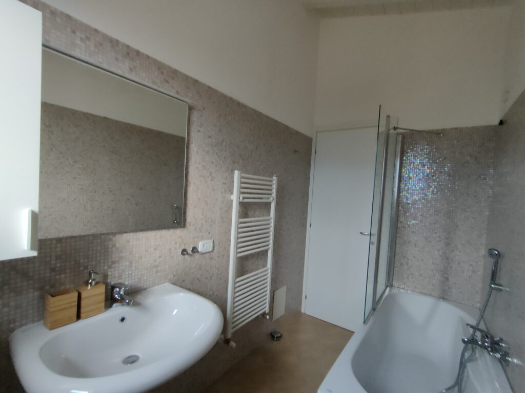 Elegant bathroom with a shower and a bidet in Casa Cuneo, a serene Fabula Home Rental property on Lake Iseo