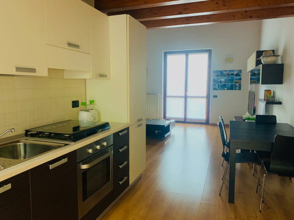 Bright and modern kitchen with dining area in La Rocca, showcasing Fabula Home Rental's taste for elegance and function