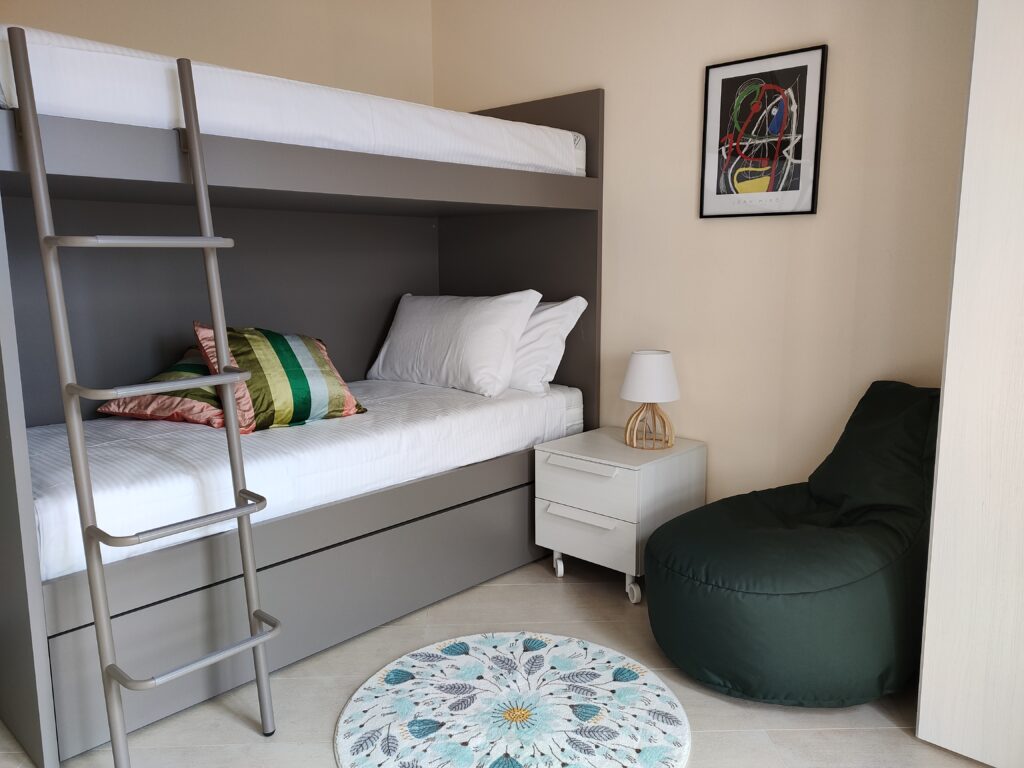 Cozy bunk bedroom with stylish decor in Fabula Home Rental's Lake Iseo home