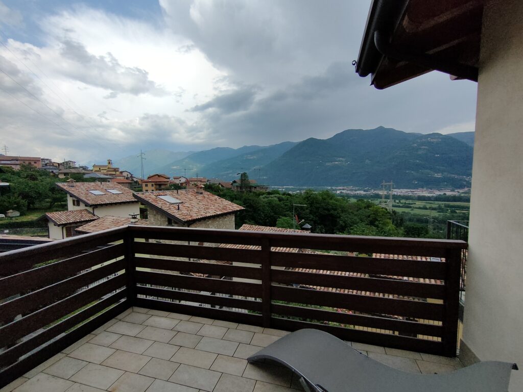 Panoramic balcony view overlooking the hills of Lake Iseo at Fabula Home Rental