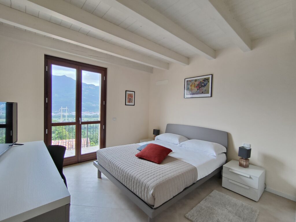 Chic bedroom with mountain views at Casa Cuneo, Fabula Home Rental's Lake Iseo destination