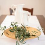 Close-up of La Stallina Primo Piano's dining table with olive branch centerpiece