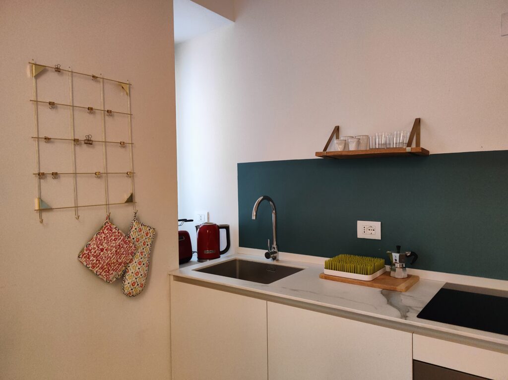 Cozy kitchen corner in Lakeview Apartment with warm wood tones and colorful kitchenware