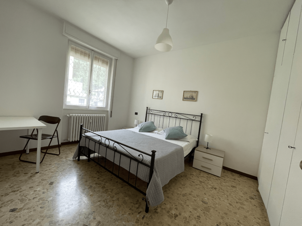 Classic Italian bedroom design with wrought-iron bed at Casa Pluto