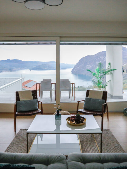 Elegant living room in modern decor with a clear view into the white kitchen space