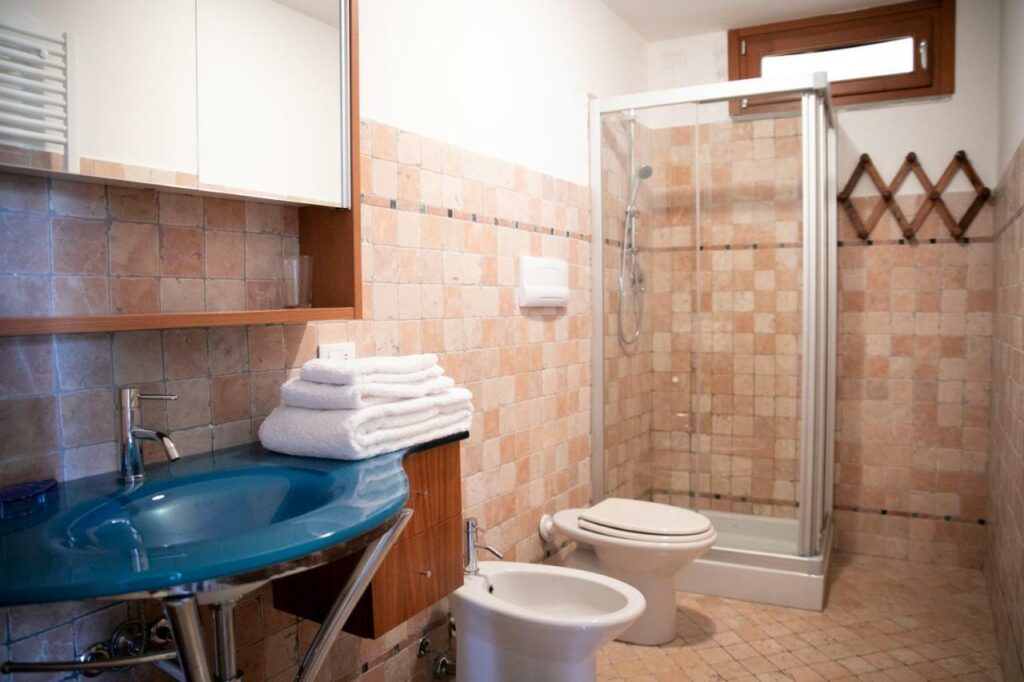 Modern shower area with terracotta tiles in La Stallina's bathroom