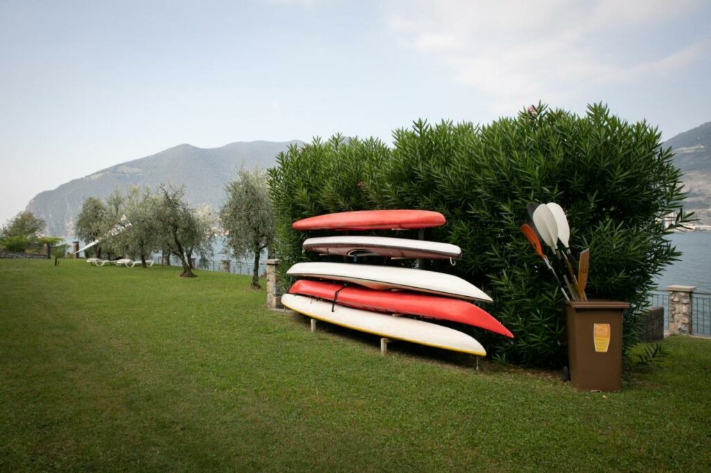 A stack of colorful canoes ready for adventure on the shores of Lake Iseo at La Stallina Ground Floor