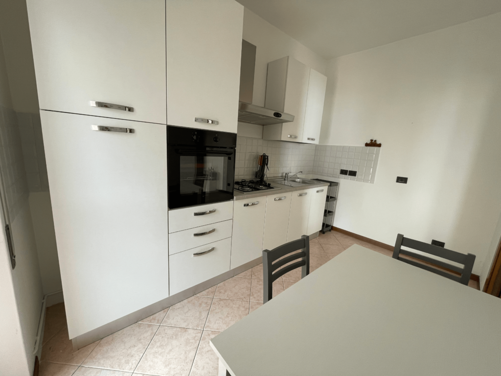 Bright and minimalist kitchen design at Casa Pluto, with white furnishings