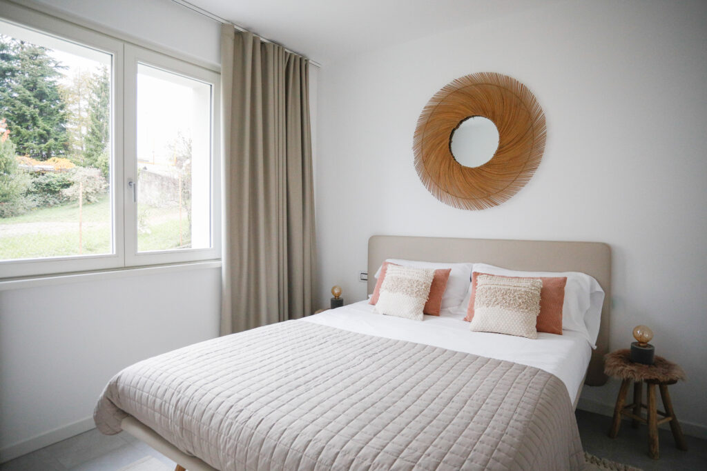 Serene bedroom with a picturesque garden view through large windows at Seliera