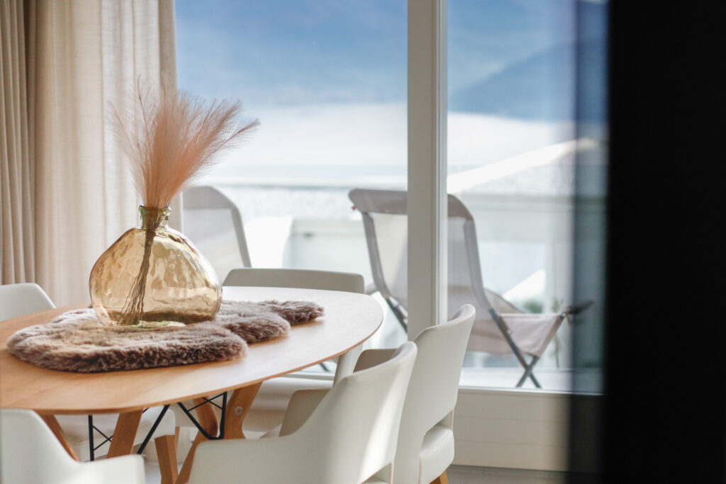 A well-lit dining area at Seliera with a balcony sea view