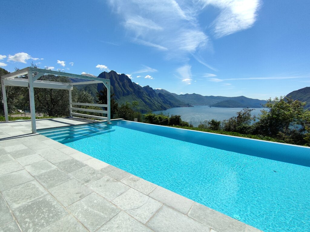 Sky-blue infinity pool at Trivia Bellavista with a panoramic mountain view