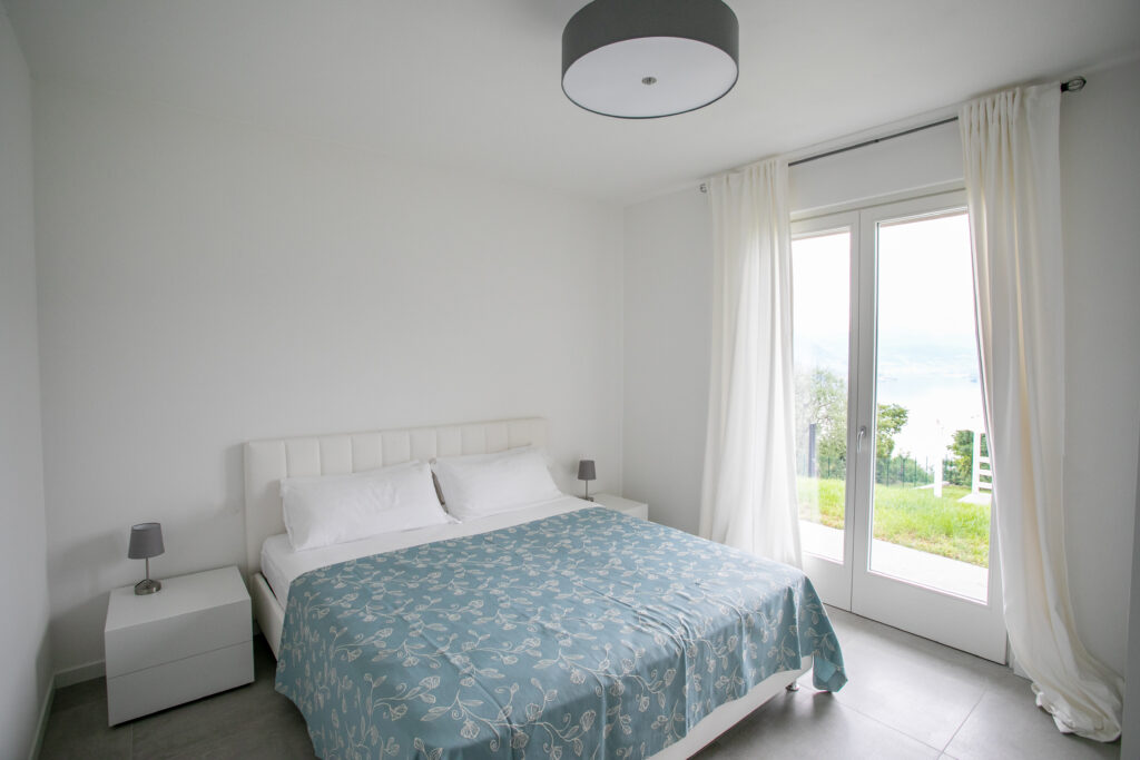 Detailed shot of elegant blue-patterned fabric on a bed at Trivia Resort, with a focus on texture and design