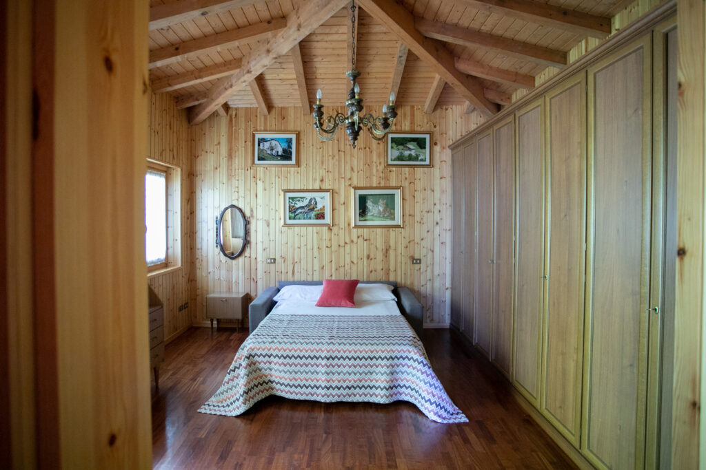 Spacious bedroom featuring wooden decor and traditional furnishings in Villa Simone