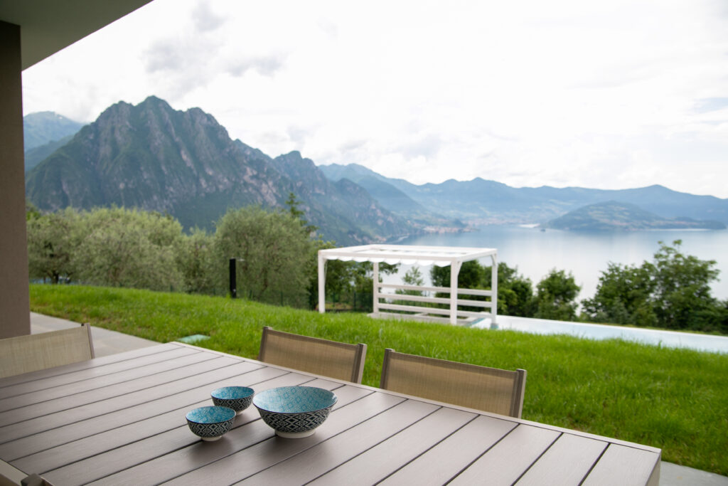 White pergola by the poolside offering a stunning view of Lake Solto