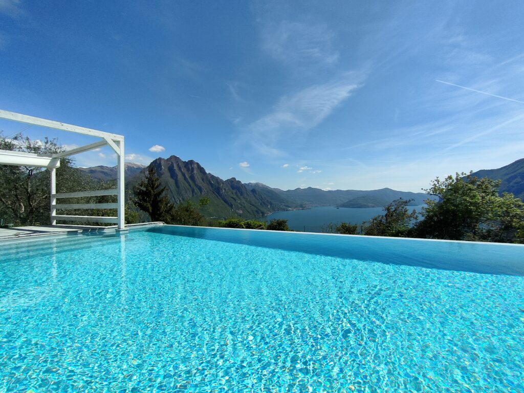 Breathtaking hillside infinity pool with panoramic views of the lake and mountains