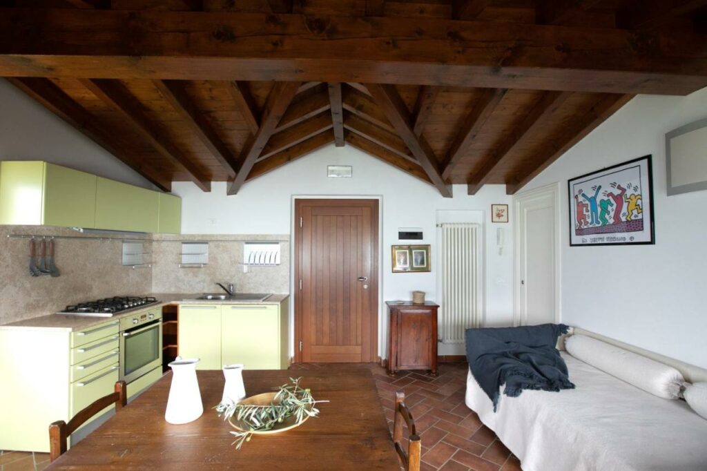 Bright and airy kitchen with dining area in La Stallina Penthouse, overlooking Lake Iseo