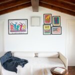 Cozy attic living room with colorful artwork in La Stallina Penthouse, Lake Iseo