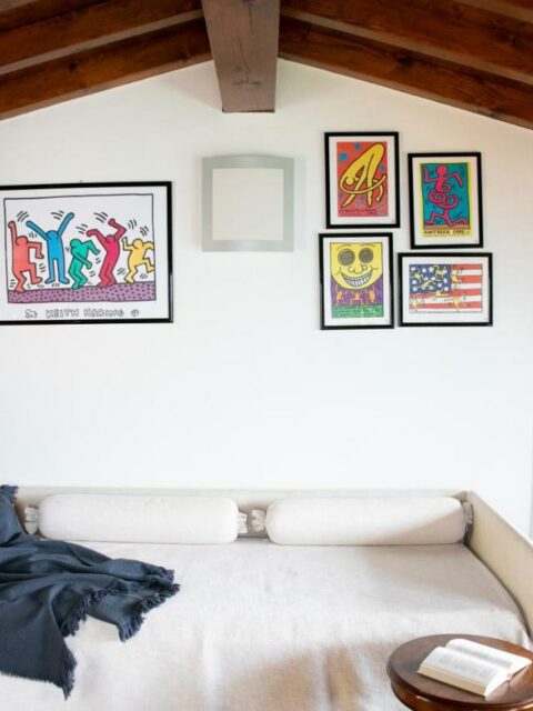 Cozy attic living room with colorful artwork in La Stallina Penthouse, Lake Iseo