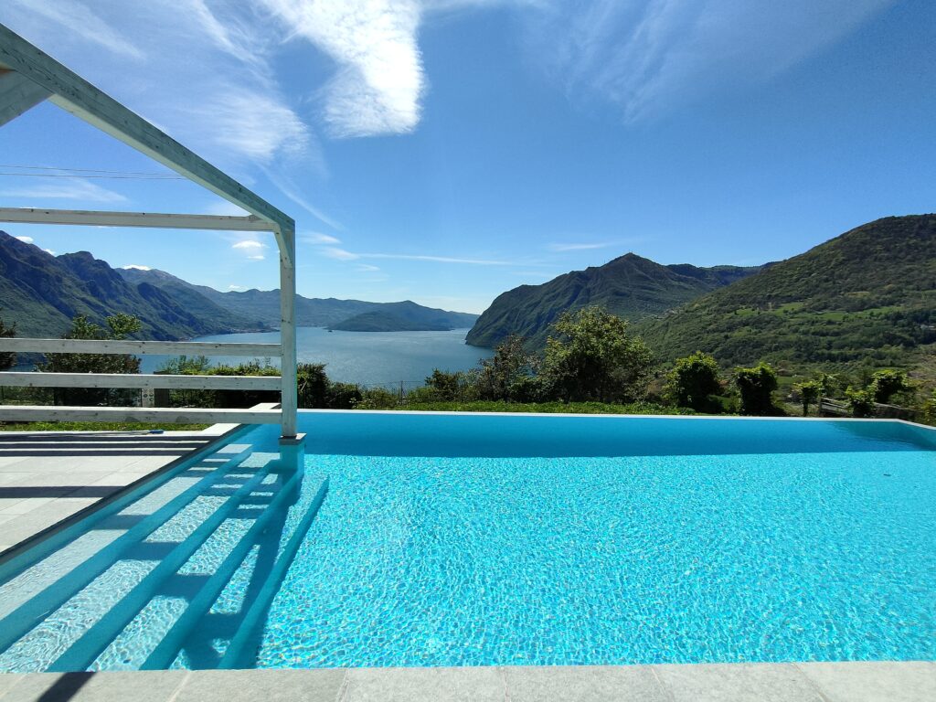 Infinity pool with panoramic mountain views and crystal-clear turquoise water