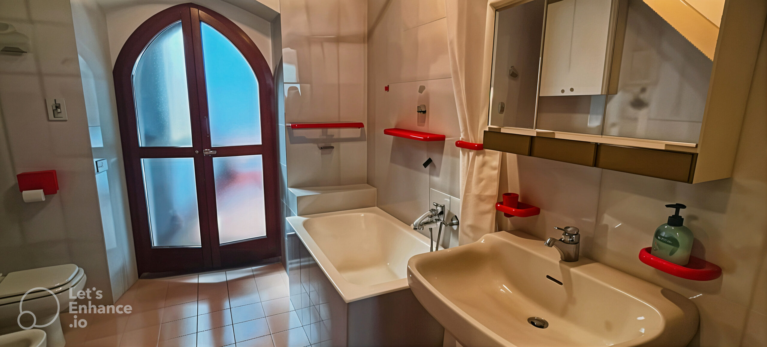 Bathroom with bathtub, sink, and access to a small balcony in La Porta Sul Lago apartment