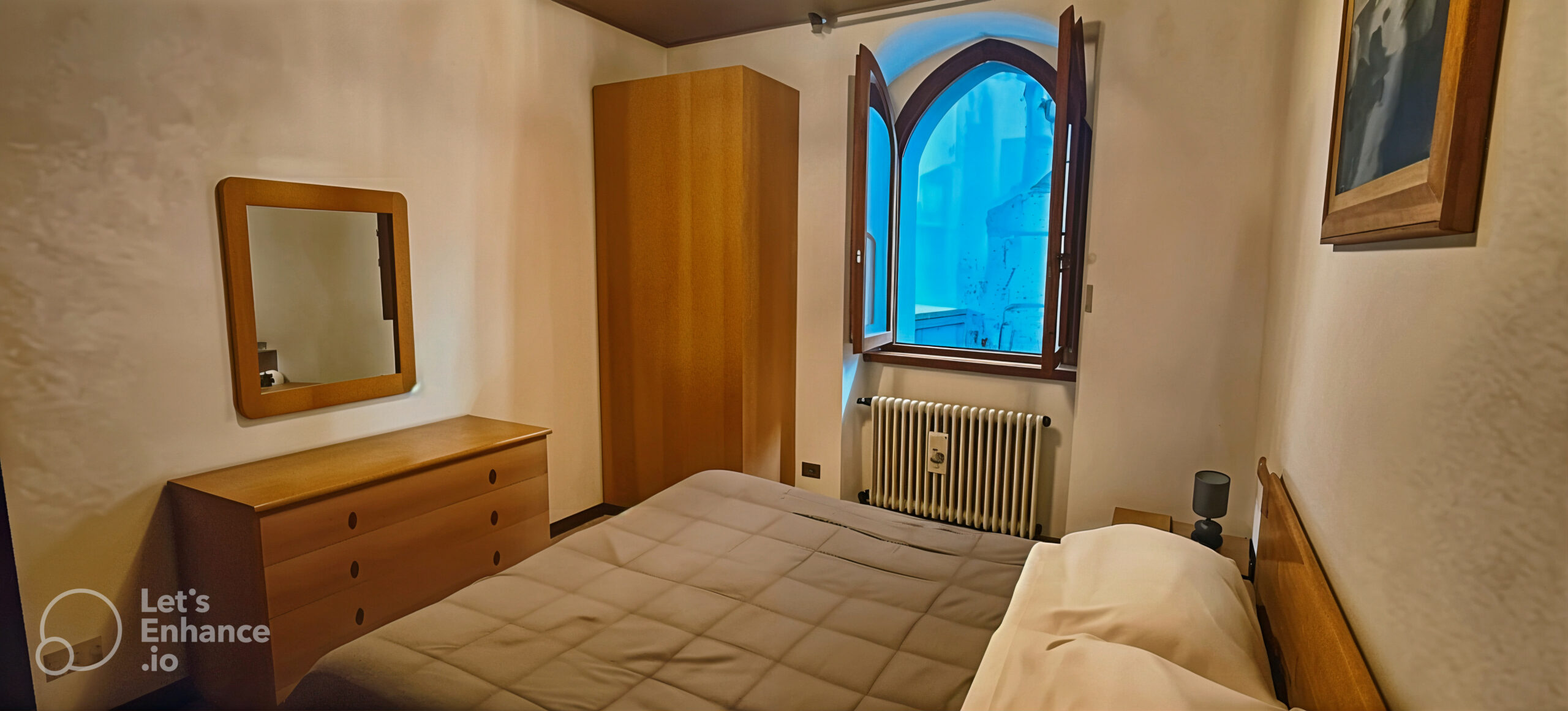 Bedroom with wooden dresser and wardrobe in La Porta Sul Lago apartment